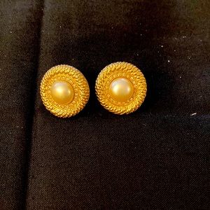 Round gold tone earrings with mark “Carolee” on the back, faux pearl centers